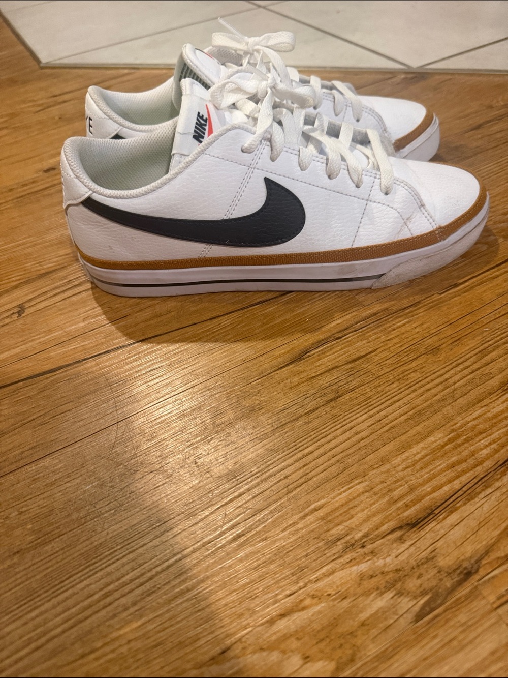 Nike White WomensSneakers with Black Swoosh and Brown Accent